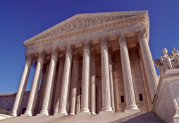 Front of the U.S. Supreme Court Building from an upward angle. © Photos.com