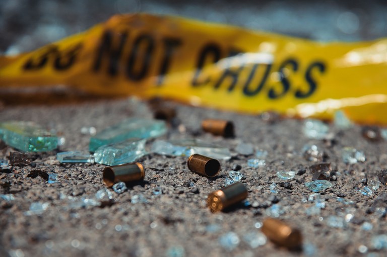 A stock image of bullet casing and crime scene tape.