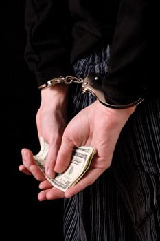Handcuffed Hands Holding Cash Behind Back