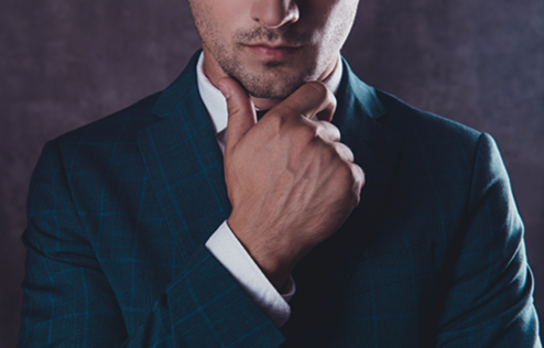 A business man is depicted with his hand on his chin thinking about business.