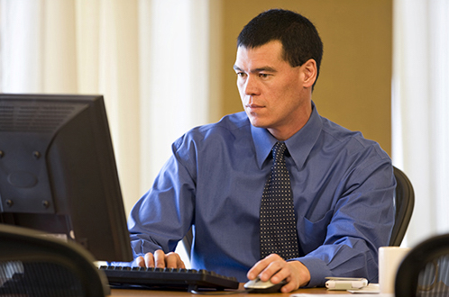 Businessman on Computer (Stock Image)