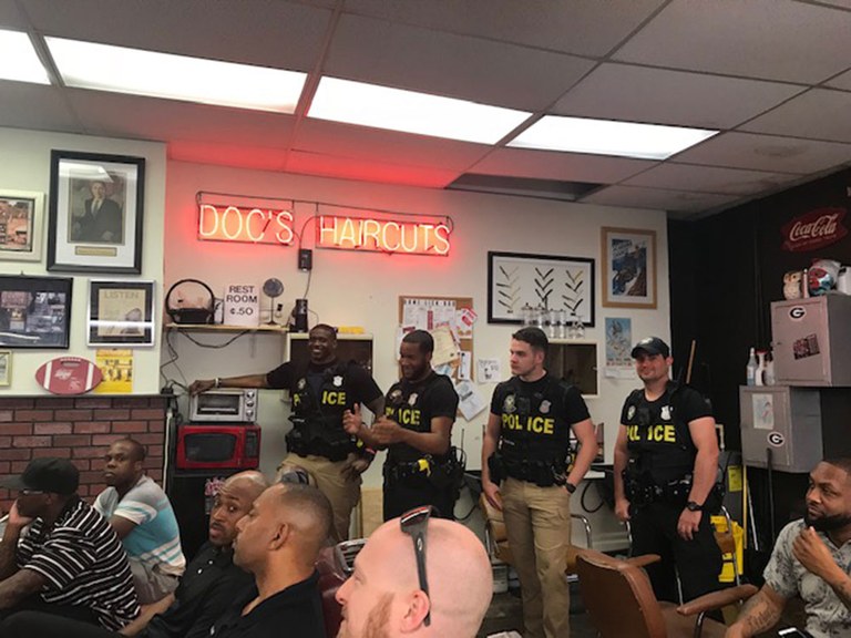 Four uniformed police officers attending a Clippers and Cops meeting.