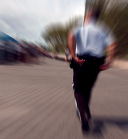 Cop Running, Blurred Image (Stock Image)
