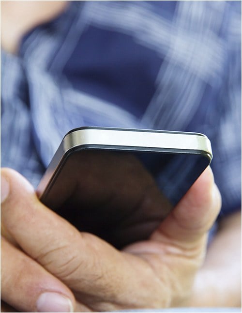 Stock image of a person holding a cell phone.