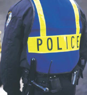 An officer wearing a protective police vest.