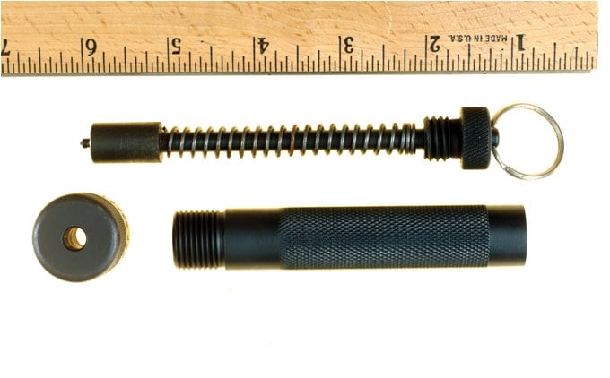 The item appears to be a flashlight but actually is a gun. The ring is pulled back and allowed to travel forward, firing a .25 auto caliber cartridge.