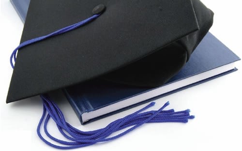 Graduation Cap on Book (Stock Image)