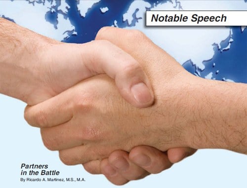 Stock image of two hands shaking superimposed over a world map.