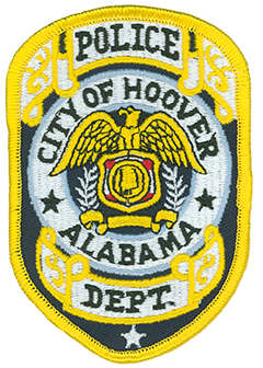 The city of Hoover, Alabama, was founded in 1954 by William H. Hoover, Sr., a local insurance salesman and developer, and incorporated on April 28, 1967. Growing from a population of 406, the city today has over 84,000 residents and is the largest suburb of Birmingham, Alabama’s largest city. The Hoover Police Department, founded in 1967, currently employs 166 officers and 62 civilian staff members. The department’s service patch features intricate scrollwork with gold edging at the top and bottom. In the center is a bald eagle with its wings spread over a shield. Within the shield is the Great Seal of Alabama, featuring a map of the state with its major rivers. 