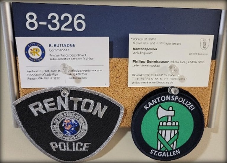 An image of the author's patch and business card along with the patch and business card of his IPP partner.