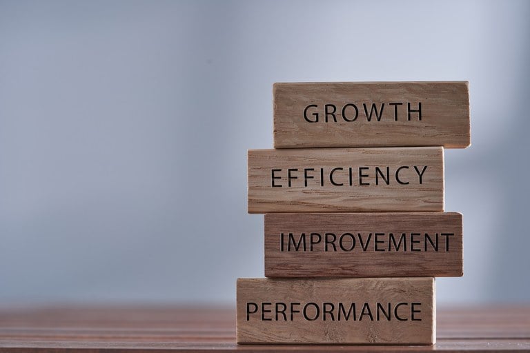 A stock image of a block tower with the words Growth, Efficiency, Improvement, and Performance.
