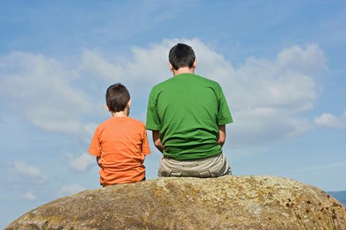 Man and Boy Sitting on Rock (Stock Image)