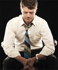 A man is depicted leaning forward in deep thought.