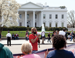 A protest at the White House is led by a man on a megaphone. © Jim Pruitt/Shutterstock.com.