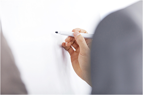 Person With a Marker in Front of a Whiteboard (Stock Image)