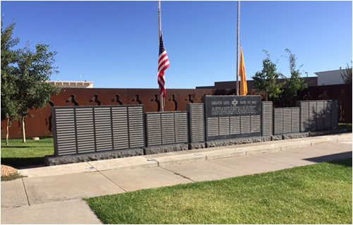 The New Mexico Law Enforcement Memorial sits in a beautiful courtyard on the grounds of the state law enforcement academy. Steel cut-out silhouettes of 28 officers guard and salute the monument’s wall, which features the names of personnel—currently 204—lost in the line of duty. United States and New Mexico flags fly at half-staff.