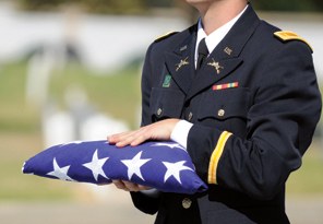 Officer Holding Folded American Flag