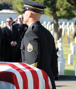 Officer Next to Flag-Draped Coffin