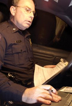Officer Working on Laptop in Car