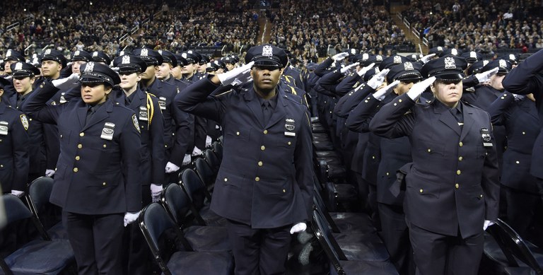 Officers Saluting During Graduation Ceremony