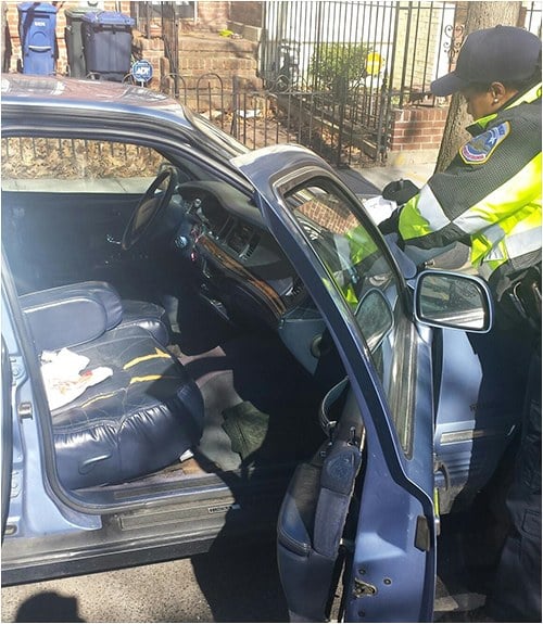 Metropolitan Police Officer leaving a brochure on the window of an unlocked vehicle