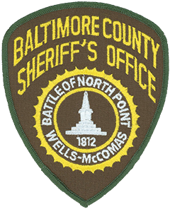 The patch of the Baltimore County, Maryland, Sheriff’s Office depicts the Wells and McComas Monument, a 21-foot obelisk built in 1873 to honor two members of the Maryland State Militia—Daniel Wells and Henry McComas—who defended Baltimore in the War of 1812. According to legend the two teenage militiamen shot and killed Major General Robert Ross, commanding officer of the British troops near the city, during the Battle of North Point on September 12, 1814. Wells and McComas both fell in battle shortly afterward and are interred beneath the monument that honors them.