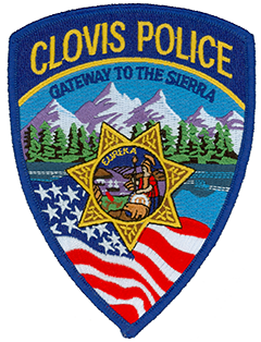  Since its incorporation in 1912, Clovis, California, has been known as the Gateway to the Sierra due to its location at the base of the Sierra Nevada mountain range in central California. The range proudly serves as the backdrop to the Clovis Police Department patch and is depicted above acres of lush forest. Clovis began in 1891 as a freight stop for the railroad and grew to include a lumber mill with a 42-mile-long log flume. The center of the patch depicts the Great Seal of California while a flowing American flag is shown in the foreground.