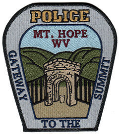 Mount Hope, West Virginia, is known locally as the “Gateway to the Summit,” which references the city’s proximity to the Bechtel Family National Scout Reserve, a new high-adventure base for the Boy Scouts of America that will serve as the location for future National Scout Jamborees. The patch of the Mount Hope Police Department depicts this gateway with a fountain—an old landmark in the city, along with the Appalachian Mountains in the background.
