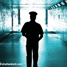 Depiction of an officer's silhouette in an empty hallway.