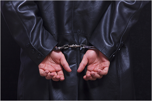 Man in Dark Jacket in Handcuffs (Stock Image)
