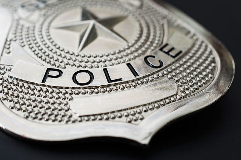 Stock image of a silver police badge.