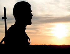 Profile Silhouette of Gunman at Sunset