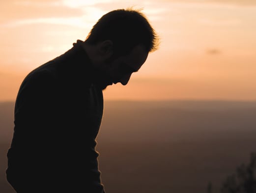 Profile Silhouette of Man with Head Down in Sunset (Stock Image)