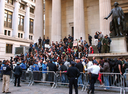 A crowd protests in public under the observation of police officers. © Daryl Lang/Shutterstock.com.