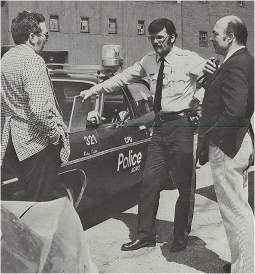 Local law enforcement agencies and railroad police in most areas have a close working relationship. In this scene, two Union Pacific special agents discuss a mutual problem with a Kansas City, Missouri, patrolman. From the February 1977 Law Enforcement Bulletin.