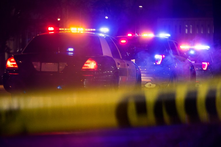 A stock image of police vehicles at a crime scene.