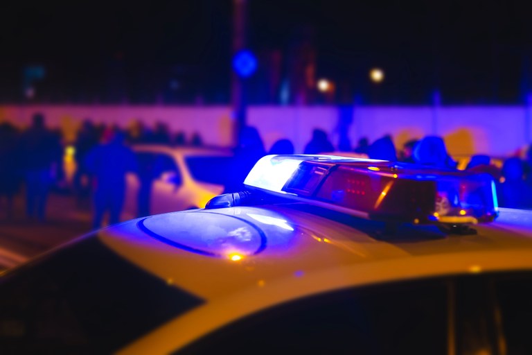 A stock image of a police vehicle in a crowded street.