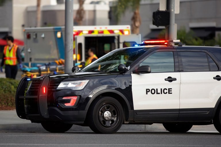 A stock image of a police vehicle and an ambulance.
