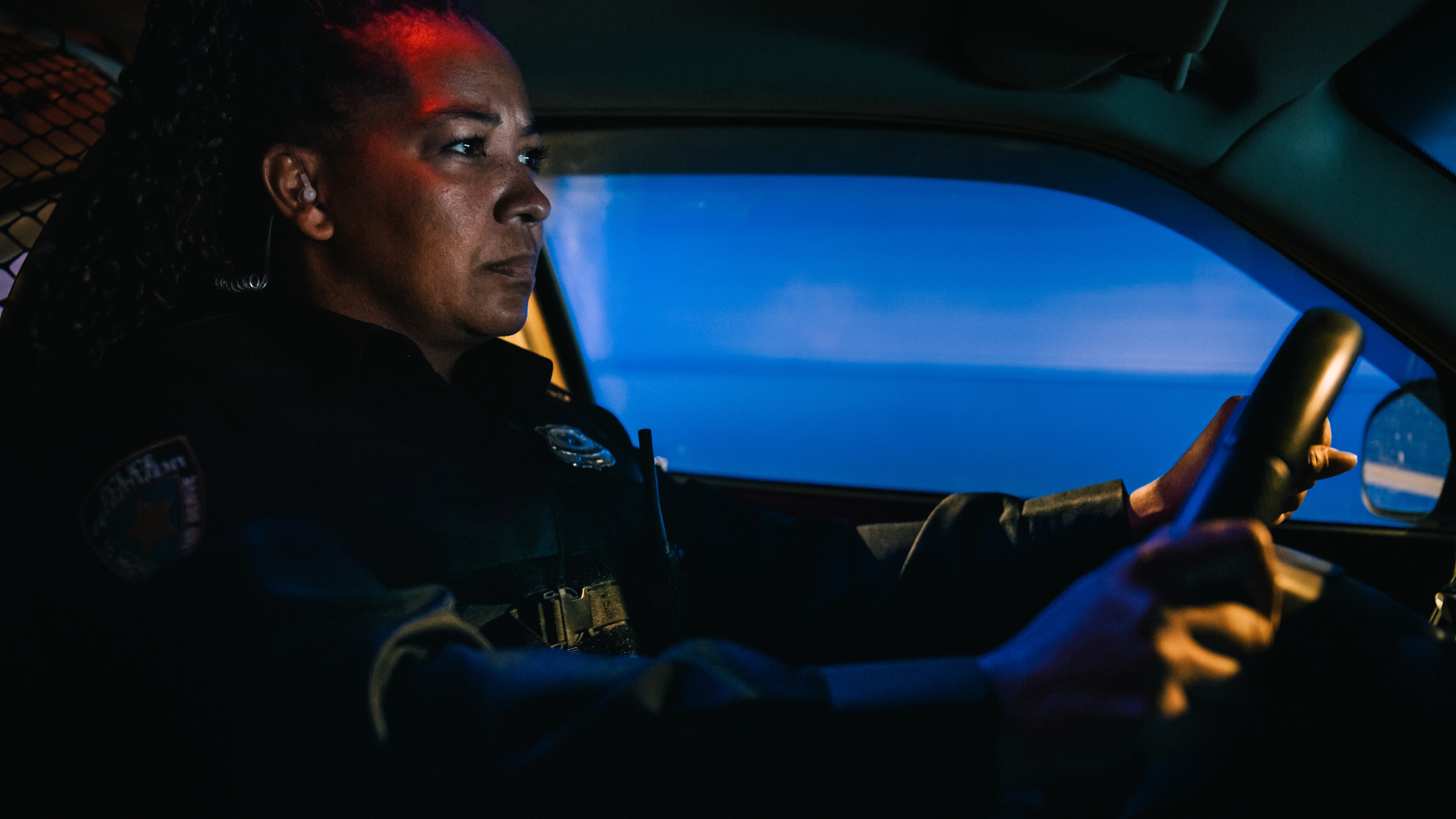 Police Officer Driving At Night
