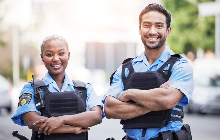 A stock image of a young female and male police officer.