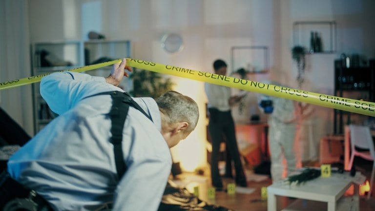 A stock image of a police detective entering a crime scene.