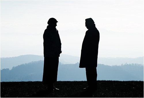 Silhouette of Men Talking (Stock Image)