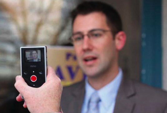 Speaking Man Being Recorded on Handheld Device