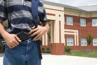 Student in Front of School with Gun in Waistband of Pants (Stock Image)
