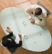 Overhead View of Two People Talking at Office Table (Stock Image)