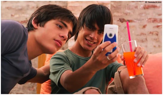 Teen Boys Looking at Cell Phone (Stock Image)