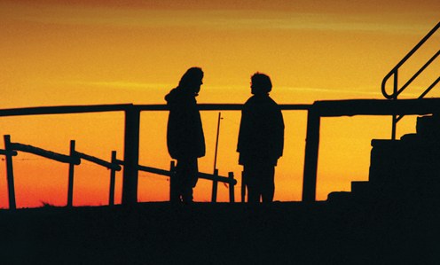 Two People Silhouetted in Sunset (Stock Image)