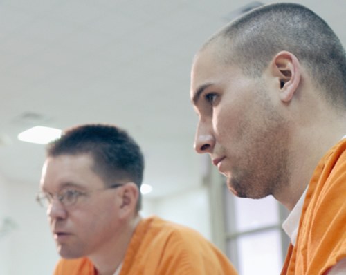 Two Prisoners in Orange Jumpsuits