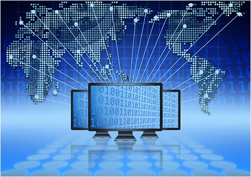 Stock image of three computer screens with computer digits and a world map in the background.