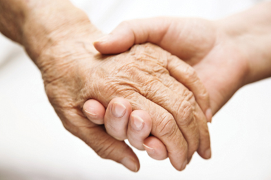 Young Hand Holding Elderly Hand (Stock Image)